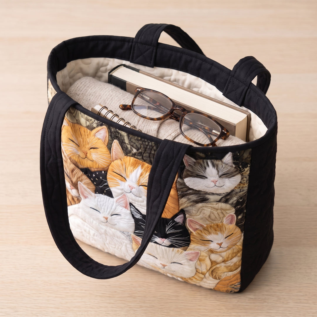 Artisanal Quilted Bag - Sleeping Kittens — packed with a hardback book, a folded cardigan and reading glasses